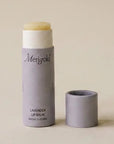 open lavender merigold lip balm on a beige background
