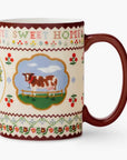 Mug with cow illustration and 'Home Sweet Home' text on a white background