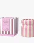 Pink and white striped candle with matching packaging on a white background