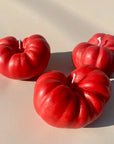 3 red tomato shaped candles