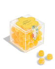 Clear cube container with yellow gummy bears labeled 'Lemon Spritz' on a white background