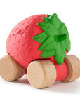 Strawberry-shaped toy with wooden wheels on a white background
