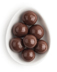 Chocolate candies in a white bowl on a white background