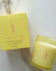 yellow leo zodiac candle on a marble background