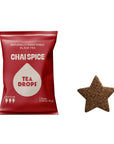 A red bag of Tea Drops Chai Spice black tea drops next to a single star-shaped tea drop on a plain white background.