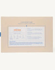 The back of a Luxe Mixer Cube spray bottle packaging box, showing product information and instructions in English and French, set against a plain off-white background.