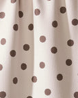 White fabric with brown polka dot pattern