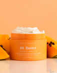 orange body butter next to papayas