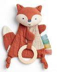 Plush fox toy with a ring on a white background