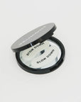 Compact mirror with 'Slow Down' text on a white background