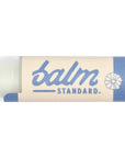 Lip balm stick with 'balm standard.' branding on a white background