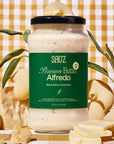 Jar of Sauz Brown Butter Alfredo sauce with a checkered background