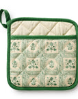 Green and beige quilted pot holder with botanical pattern on a white background