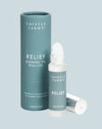 Thistle Farms Relief Essential Oil Roll-On on a light blue background