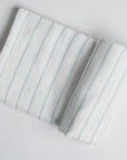 Powder Blue Stripe Swaddle on white background.