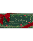 A Sugarfina holiday candy Bento box in dark green wrapping paper decorated with gold foil pine branches, red berries, and a large red velvet bow, on a white background.