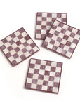Four checkered coasters with a maroon and white pattern on a white background
