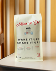 coffee bag with picture of a house with a red door on it that says 'Mom 'N 'Em' in red