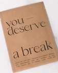 Kraft paper product packaging with 'you deserve a break' text on a white background