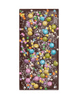 Chocolate bar with colorful candies on a white background