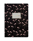 Notebook with pink floral pattern on a black background