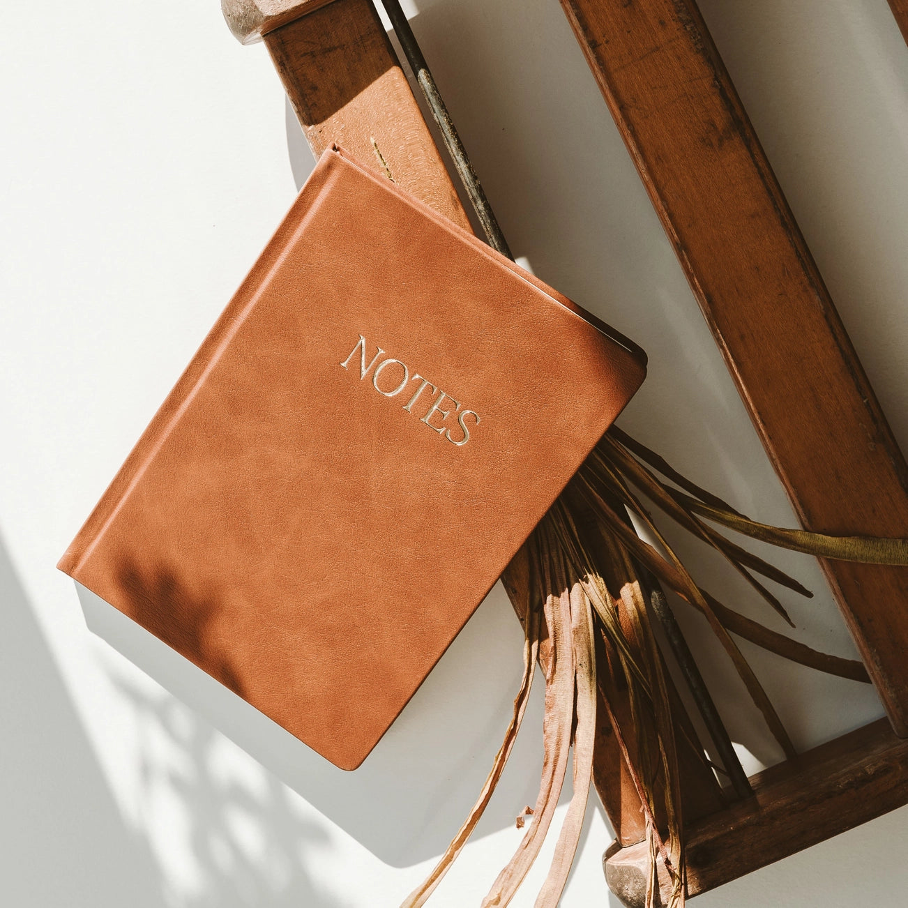 brown leather journal that says 'NOTES' on it in gold