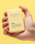 hand holding yellow limon pocket hand sanitizer