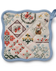 Quilted pot holder with floral and geometric patterns on a white background