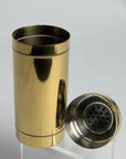 Gold and silver cocktail shaker on a light gray background