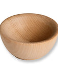 A small, round wooden bowl with a smooth, polished finish and visible wood grain, shown on a plain white background with a soft drop shadow.