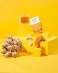 Tea packaging with a glass of tea and ginger root on a yellow background