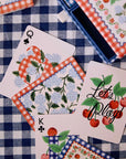 rifle paper co picnic playing cards on a blue gingham tablecloth