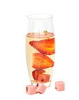Glass of champagne with sliced strawberries on a white background