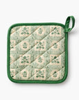 Quilted pot holder with green border and floral pattern on a white background