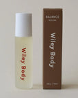 A bottle of Wiley Body Balance Roller next to its brown cardboard packaging box, set against a plain light beige background.