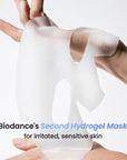 Biodance's Second Hydrogel Mask being held between two hands with a white background.