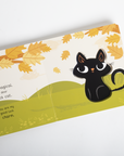 Illustration of a black cat on a leaf-patterned background with text.