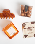 Tortoiseshell hair clip, coffee container, and craftmix Espresso Martini package on a white background