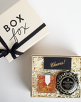 Gift set with Voluspa product and 'Box Fox' branded box on a white background