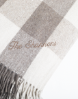 Checkered blanket with 'The Shannons' embroidery on a white background