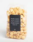 Packaged caramel popcorn with a label on a white background
