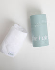 White hair towel and light blue cylindrical container on a white background