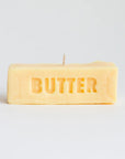 Rectangular candle with 'BUTTER' text on a light gray background