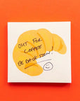 Note with a cartoon face and text 'Out for coffee, be back soon!' on an orange background