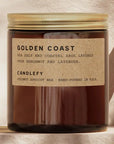 Candle with 'Golden Coast' label on a neutral background