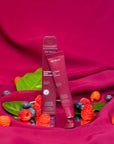purple lip gloss next to blueberries & raspberries