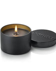 Black candle in a tin with 'Apotheke' branding on a white background