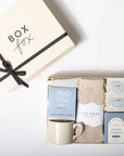 Gift set with tea, socks, and bath items from Box Fox on a white background