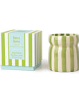 Green and white striped candle with matching box on a white background