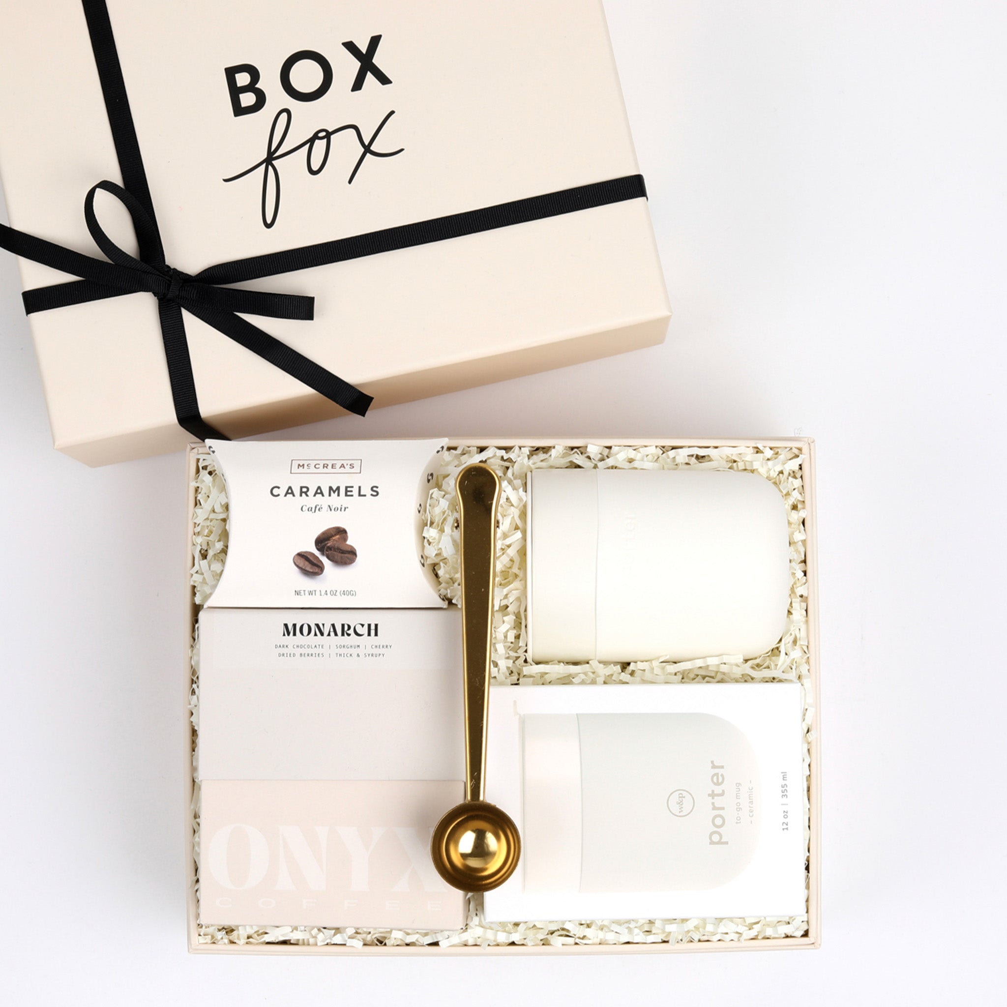 Gold coffee scoop, coffee caramels, cream mug and box of coffee packed in BOXFOX